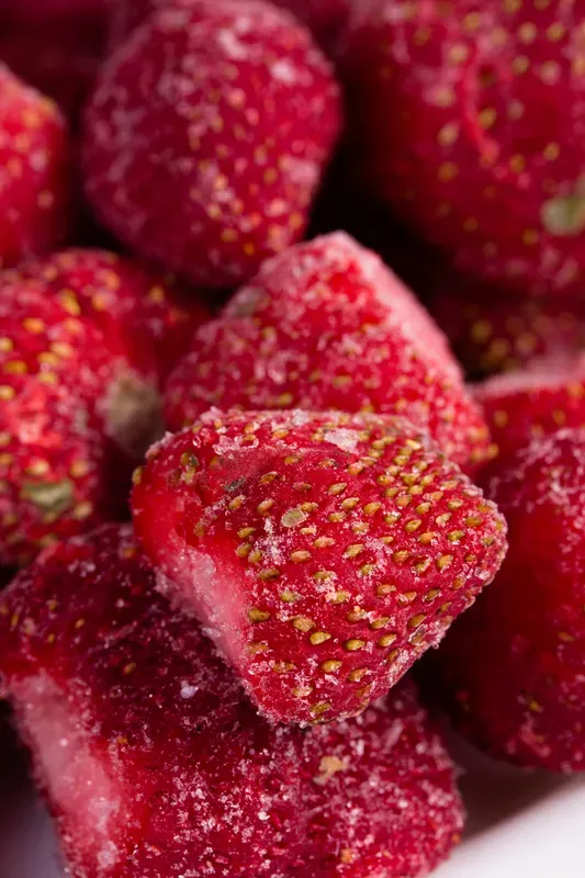 Big fresh red strawberries, frozen quickly, closeup.